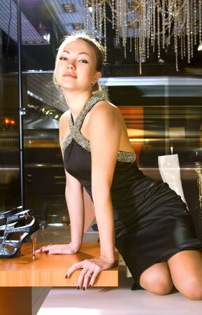 beautiful blonde woman near shop window of shopping mallの写真素材