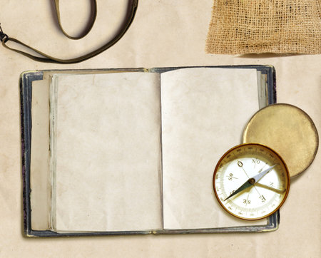 ancient logbook and compass on faded paper, copyspaceの写真素材