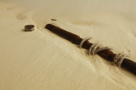 fragments from ship-wreck scattered on sand near seaの写真素材