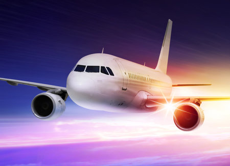 passenger plane is accelerated at sunset