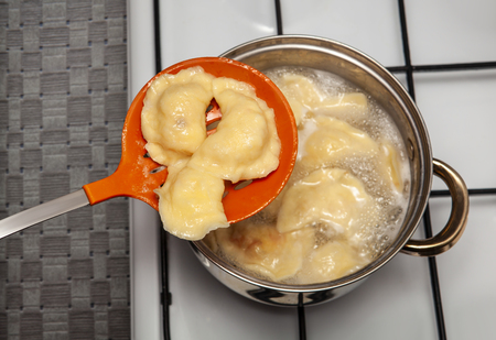Vareniki in a pan which is on a cooking surfaceの写真素材