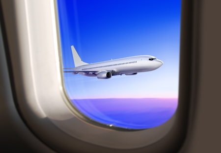 commercial plane flies in the sky, view from the window of airplaneの写真素材