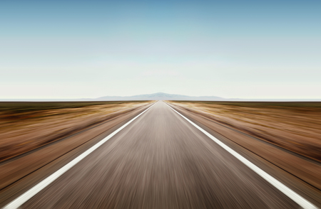 asphalt road through desert droughty area in summer dayの写真素材