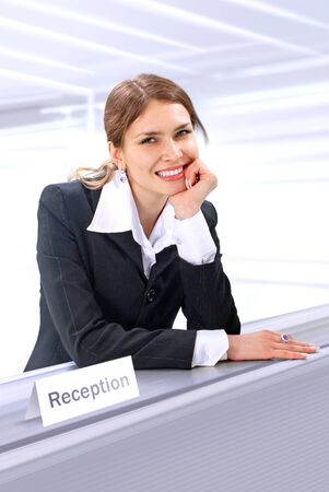 beautiful receptionist stands near the desk in hotelの写真素材