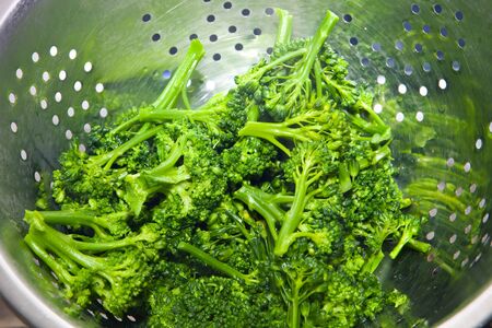 Boiled broccoli in a druschlag. Cooking of useful organic food.の写真素材
