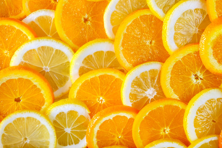 Abstract background of sliced ??orange and lemon. Close-up view.の写真素材
