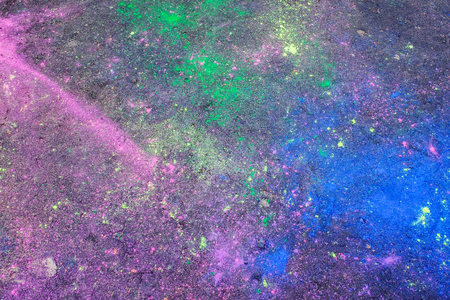 Abstract colorful blemishes on asphalt surface after holi festival. Copy space for text.の写真素材