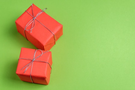 Two festive presents on green pastel background.の写真素材