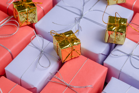 A few small golden colored presents on above of giftsの写真素材