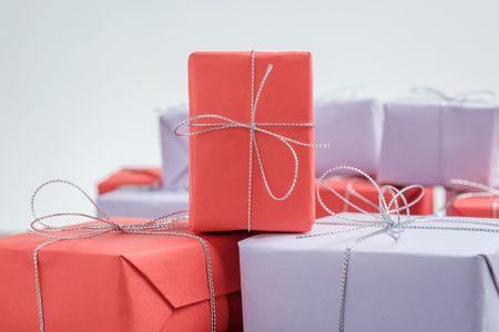 Gift wrapped in red paper and tied with silver twineの写真素材