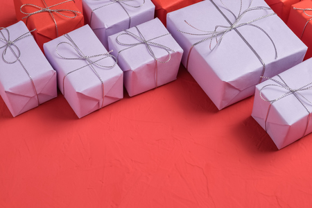 The mix of presents wrapped in lilac and red paperの写真素材