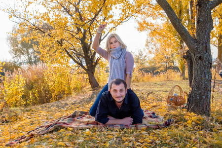 Young beautiful couple in autumn park. Happy family relationships concept.の写真素材