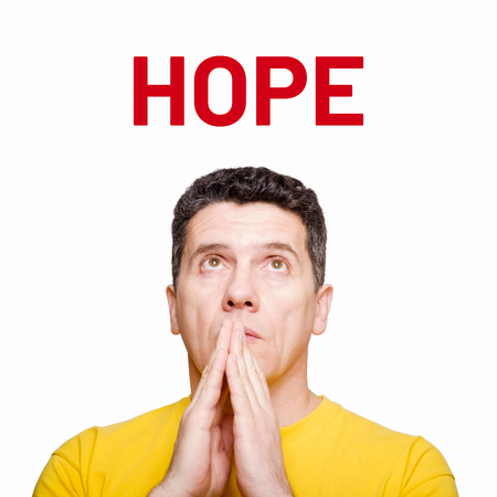 Portrait adult mature man praying and looking up on word hope isolated on  white backgroundの写真素材