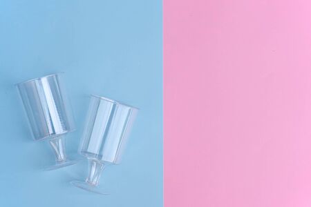 transparent plastic utensils for desserts in pastel pink and blue colors. Copy space, flat layの写真素材