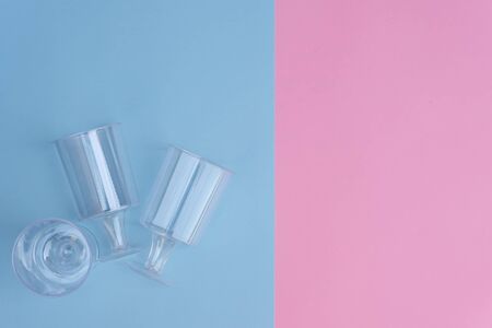 transparent plastic utensils for desserts in pastel pink and blue colors. Copy space, flat layの写真素材