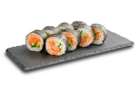 Sushi Rolls with salmon and cucumber wrapped in nori leaf on black slate or stone shale surface isolated on white background.の写真素材