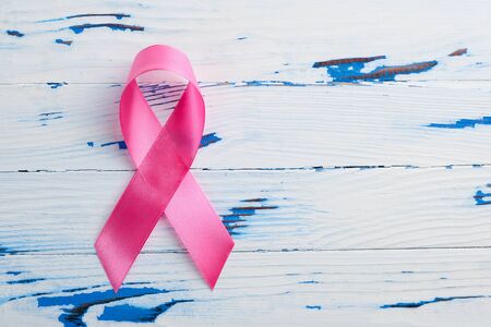 Pink ribbon on a wooden table. Breast Cancer Awareness Monthの写真素材