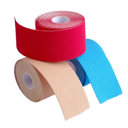 stack of three rolls kinesiology tape for athletes isolated on white background. Kinesiology taping manipulate nerve receptors and reduces pain in muscles and speeds up the healing processの写真素材