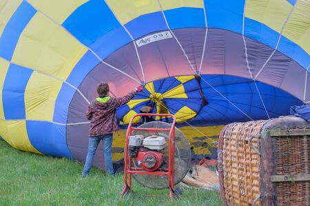 Pereyaslav, Kyiv region, Ukraine - May 6, 2018: Crew inflate hot air balloon in forest meadow in Ukraine, Europe.のeditorial素材