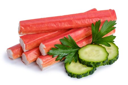 Pile of crab sticks, slices of cucumber and parsley leaf isolated on white backgroundの写真素材