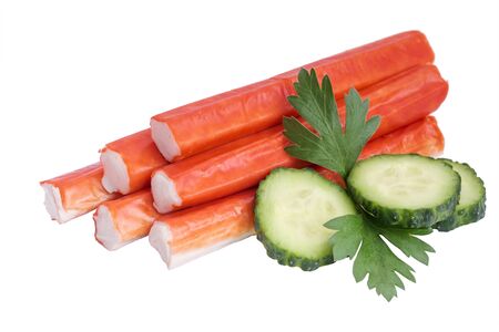 Heap of crab sticks, slices of cucumber and parsley leaf isolated on white backgroundの写真素材