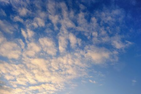 Cirrus clouds on blue sky at sunset in winter.の写真素材