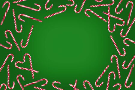 Red and white candy canes on green christmas background. Flat lay, copy space for textの写真素材