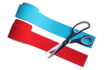 two rolls kinesiology tape for athletes and scissors isolated on white background, top view. Kinesiology taping manipulate nerve receptors and reduces pain in muscles and speeds up the healing processの写真素材