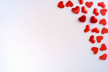 Festive composition from red hearts scattered on white background, valentines day concept, copy space for text, flatlayの写真素材