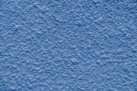 painted in trendy color of year 2020 Blue Classic chipped plaster on the weathered wall. close up viewの写真素材