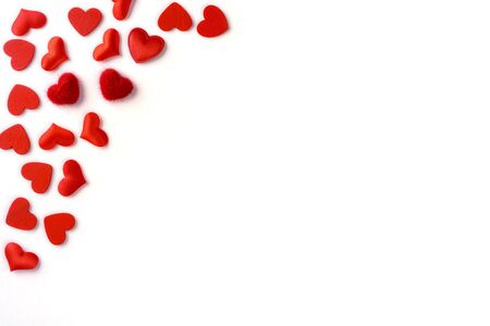 Festive composition from red hearts scattered and isolated on white background, valentines day concept, copy space for text, flatlayの写真素材