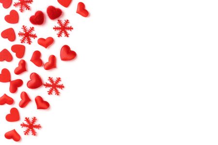 Festive composition from red hearts and snowflakes scattered and isolated on white background, valentines day concept, copy space for text, flatlayの写真素材