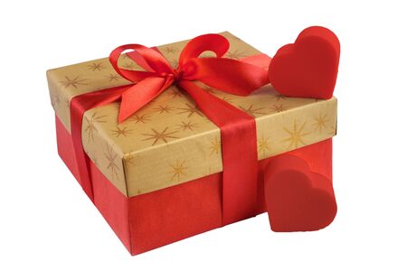 Red gift or present box with golden colored top and red ribbon bow, two hearts isolated on white background, for sales, birthday, valentine, mother day or christmasの写真素材