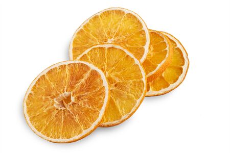 Stack of dried orange slices isolated on white background.の写真素材