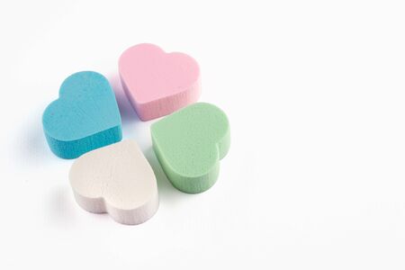 Assorted pink, blue, green and white pastel cosmetic sponges in heart shape on white background. skin care and beauty concept. Close up viewの写真素材