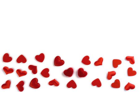 Festive composition from red hearts scattered and isolated on white background, valentines day concept, copy space for text, flatlayの写真素材