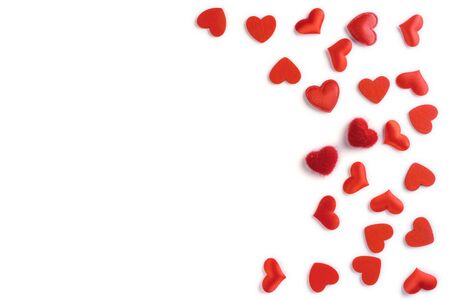 Festive composition from red hearts scattered and isolated on white background, valentines day concept, copy space for text, flatlayの写真素材