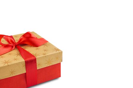 Red gift or present box with golden colored top and red ribbon bow isolated on white background, for sales, birthday, mother day or christmasの写真素材