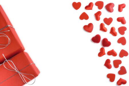 Festive composition from tied red gift box, snowflakes and hearts scattered on white background, valentines day concept, copy space for text, flatlayの写真素材