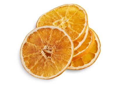 Stack of dried orange slices isolated on white background.の写真素材