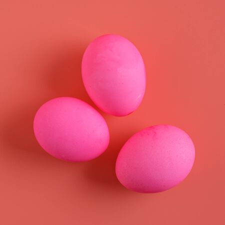 Three Easter Eggs On Pink Background, flat lay, top viewの写真素材