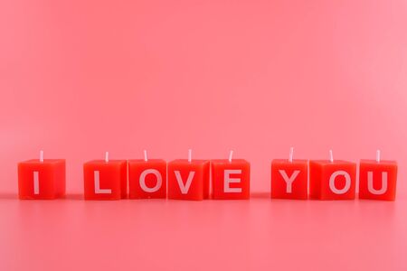 candle arranging i love you word on pink background, copy spaceの写真素材