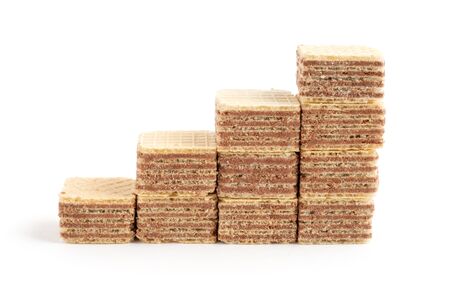 Pile of square wafer biscuits in the row ascending isolated on white backgroundの写真素材