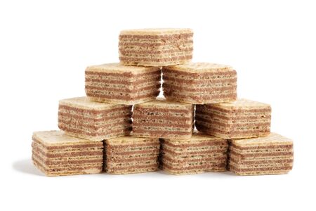 Pile of square wafer biscuits in shape of pyramid isolated on white backgroundの写真素材