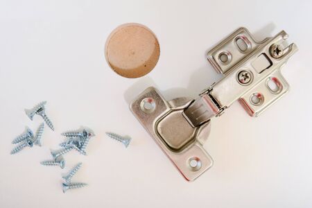 furniture hinge in the new kitchen cabinet door closeup, flat layの写真素材
