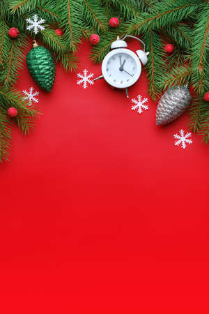Top view Christmas composition with spruce branches and toys on red backgroundの写真素材