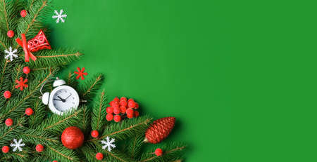 Top view Christmas composition with spruce branches and toys on green backgroundの写真素材
