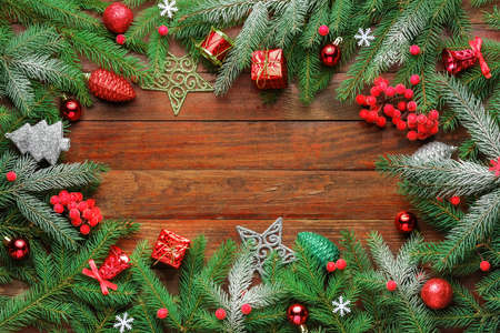 Christmas spruce branches with berries, toys and Christmas decorations frame.の写真素材