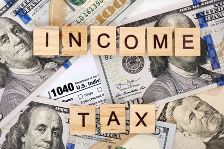 Close-up personal income tax form 1040, dollar bills. Tax payment and filing concept.の写真素材
