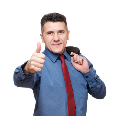 Portrait smiling handsome man wearing blue shirt and red necktie showing thumb up isolated over white backgroundの写真素材